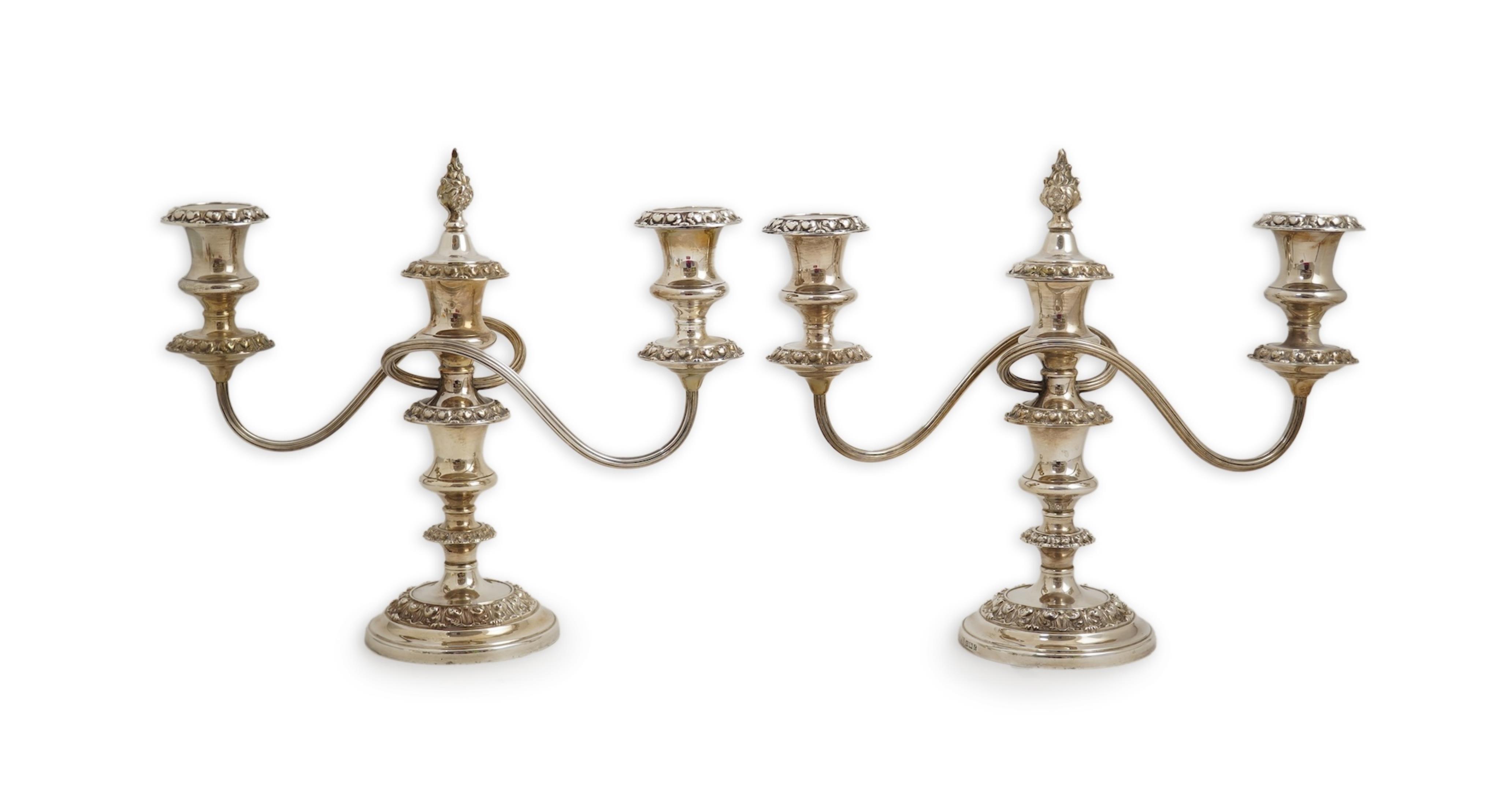 A pair of Elizabeth II silver dwarf two branch, three light candelabra by Barker Brothers Silver Co